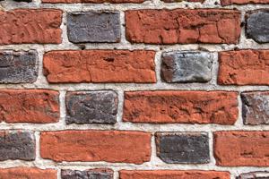 Water-struck bricks laid in glazed-header, Flemish bond pattern;