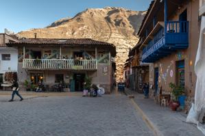 House with balcony in shadow of mountain