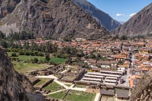 Archaeological ruins and village; granary on mountain in backgro