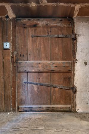 Board and battem door in attic hung on reused hinges, 1792