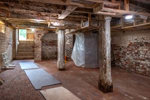 Original post to support 1st-floor girt in cellar; chimney vault