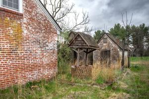 Well and outbuildings behind 1790s wing.