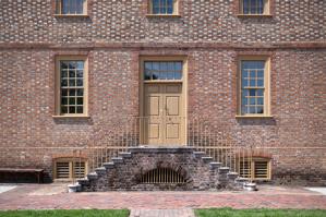 Glazed-header Flemish bond brickwork with rubbed dressings, buil