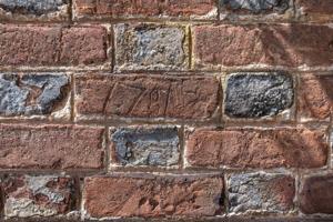Graffiti enscribed in brick 1781; remnants of yellow ocher lim