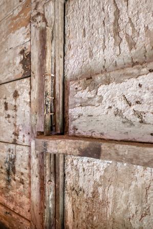 Wooden hinge and pnitel on stair door, double-pen log quarter, 2