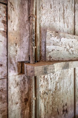 Wooden hinge and pnitel on stair door, double-pen log quarter, 2