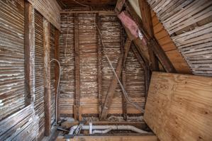 Partition on second story showing rafter bracce buried within; 1