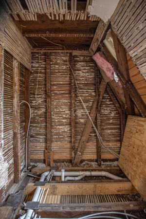 Partition on second story showing rafter bracce buried within; 1