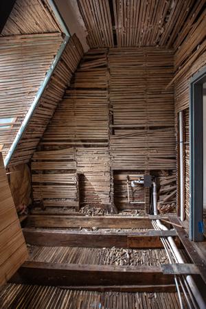 Partition on second story showing rafter bracce buried within; 1