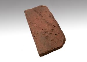 Brick paver recovered from yard between the kitchen and Maryland