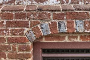 Detail of cellar window arch with alternating glazed headers; 17
