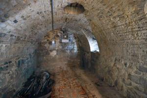 One of 3 vaults off front of house built with stones and slop-mo